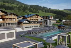 Moderner Outdoor-Pool mit Liegen im alpinen Lifestyle-Resort Hofgut Wagrain, umgeben von stilvollen Apartments und Bergkulisse im Sommer.