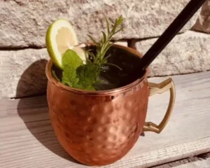 Refreshing cocktail in a stylish copper cup - flavoured with lemon, mint and rosemary. Summery moments of pleasure on the terrace of Hofgut Wagrain, where alpine lightness meets culinary sophistication.