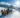 Horse-drawn sleigh ride through a snowy winter landscape in the sunshine.