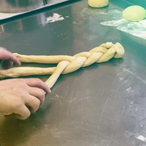With skilful hands, three strands of dough are lovingly woven into an Easter plait - handmade baking art and anticipation of fragrant enjoyment at Hofgut Wagrain.