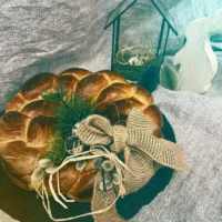 Golden-brown baked Easter plait, festively decorated with natural materials - a loving Easter greeting from the Hofgut bakery full of warmth, tradition and enjoyment.