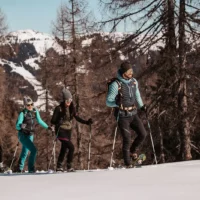 Winter adventures for the whole family - snowshoeing in the snow-covered mountains around Hofgut Wagrain, with bright sunshine and panoramic views of the Alps.