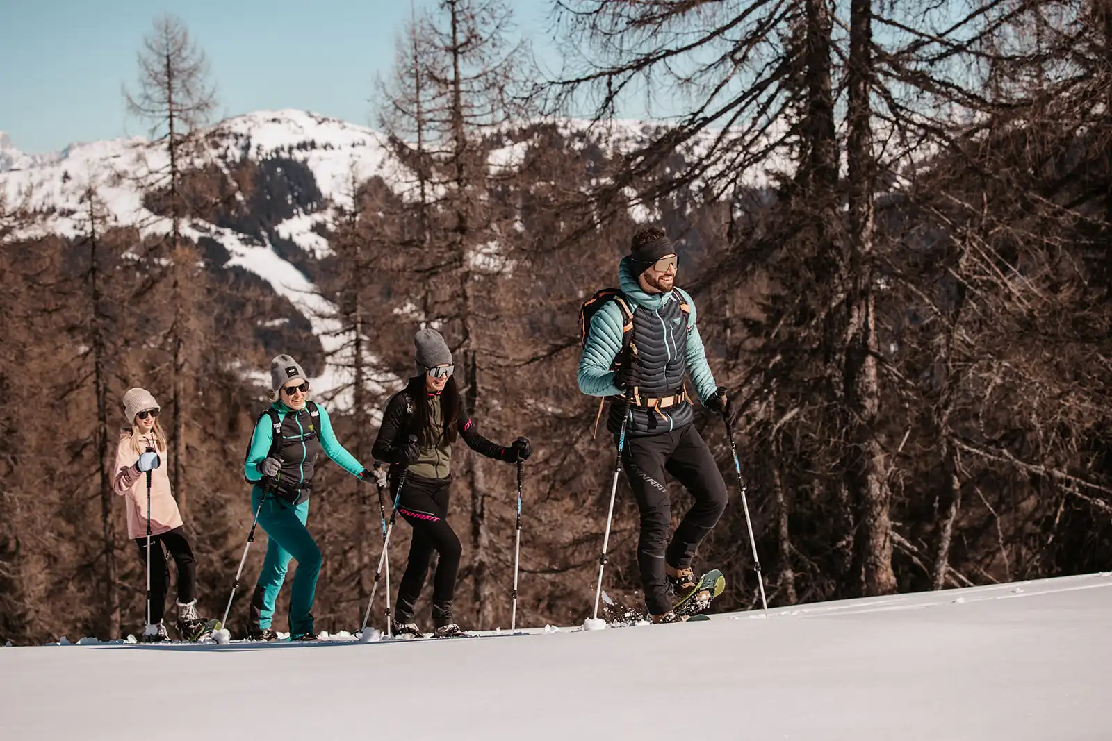 Winteravonturen voor het hele gezin - sneeuwschoenwandelen in de besneeuwde bergen rond Hofgut Wagrain, met stralende zon en panoramisch uitzicht op de Alpen.