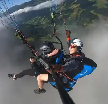 Free as the wind - tandem paragliding above the clouds with spectacular views of the Salzburg mountains.