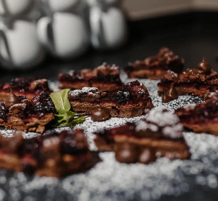 Homemade chocolate cakes with berries and mint - sweet temptation at Hofgut Wagrain, lovingly prepared and refined with powdered sugar.