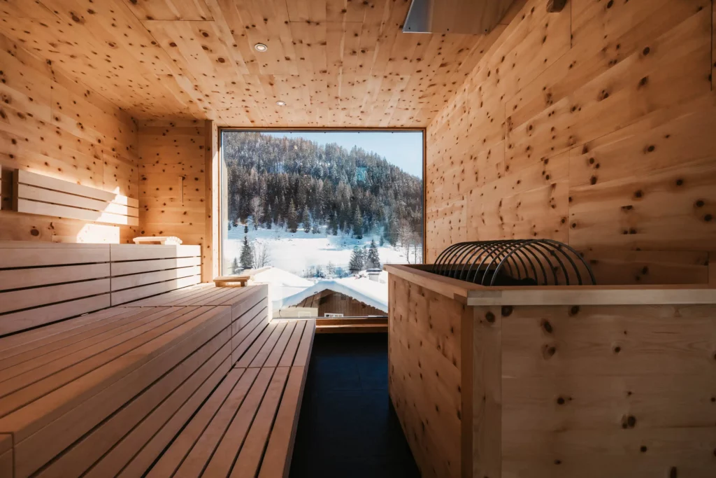 Hofgut-aparment-lifestyle-resort-wagrain-adults-only-zirbensauna-winter-89 Swiss stone pine sauna in the adults-only spa at Hofgut Wagrain - soothing warmth, the scent of natural wood and panoramic views of the snow-covered winter landscape.