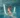 A girl laughs as she plays with a pool noodle in the water.