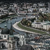 View of Salzburg's new town along the Salzach river with bridges and domes.