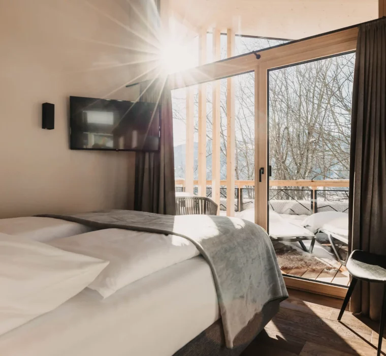 Wake up with sunshine and mountain views - your bedroom at Hofgut Wagrain.