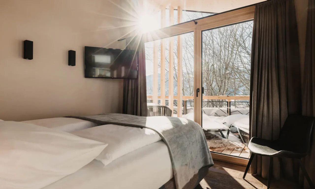 Wake up with sunshine and mountain views - your bedroom at Hofgut Wagrain.