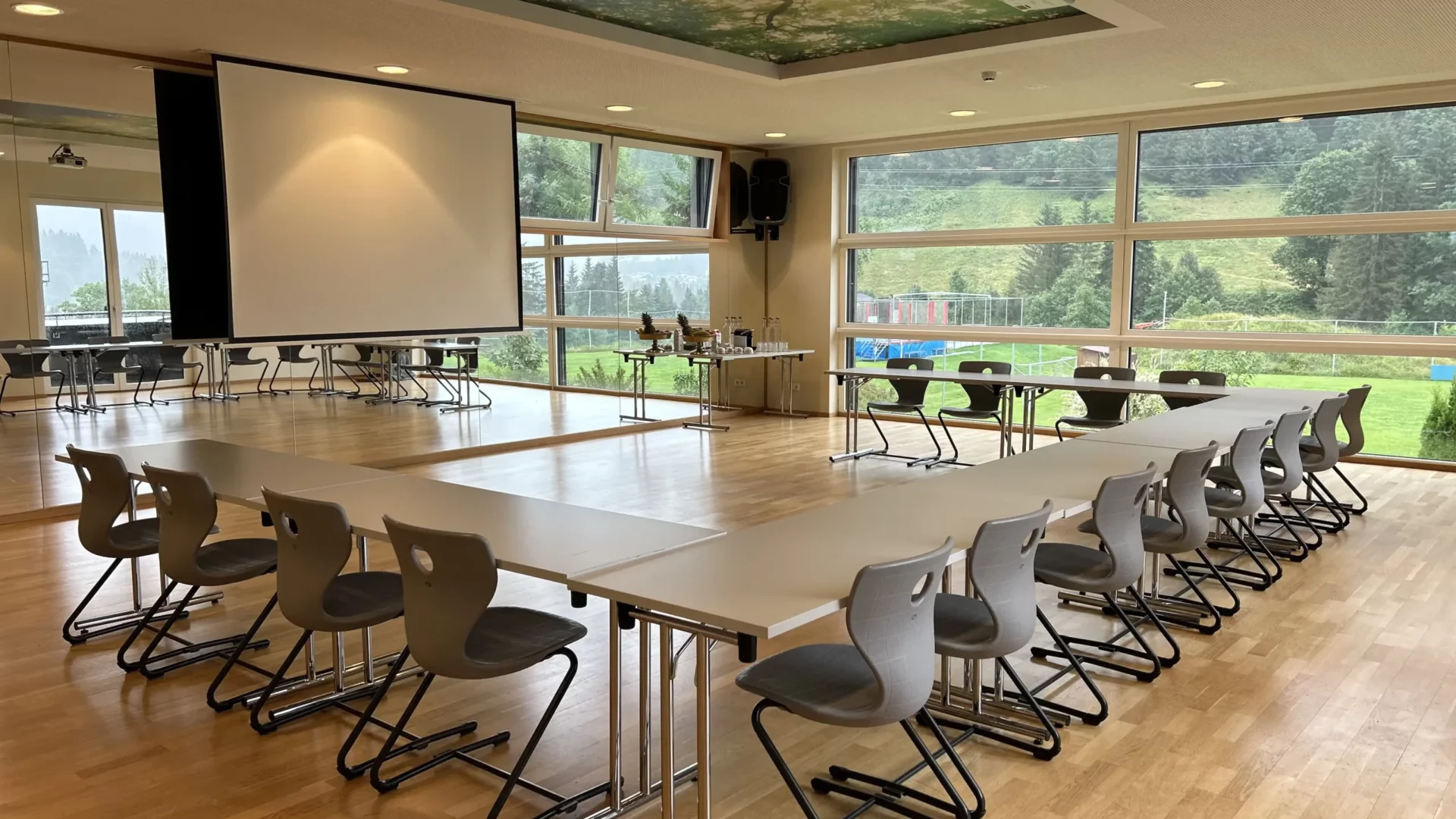 Bright seminar room with modern equipment, panoramic windows and screen in the conference area of a resort